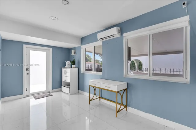 a view of kitchen with refrigerator and window