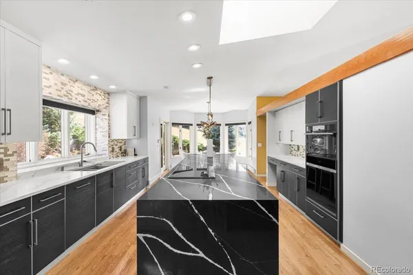 a kitchen with stainless steel appliances kitchen island granite countertop a sink and cabinets