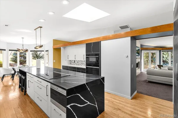 a kitchen with stainless steel appliances granite countertop a sink and a refrigerator