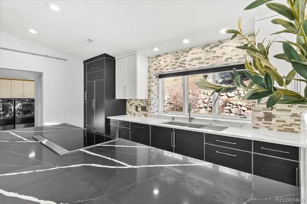 a kitchen with stainless steel appliances a sink and cabinets