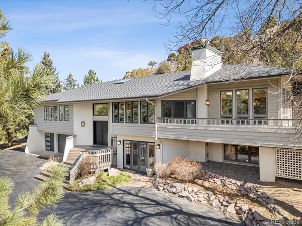 a view of a house with a yard and sitting area
