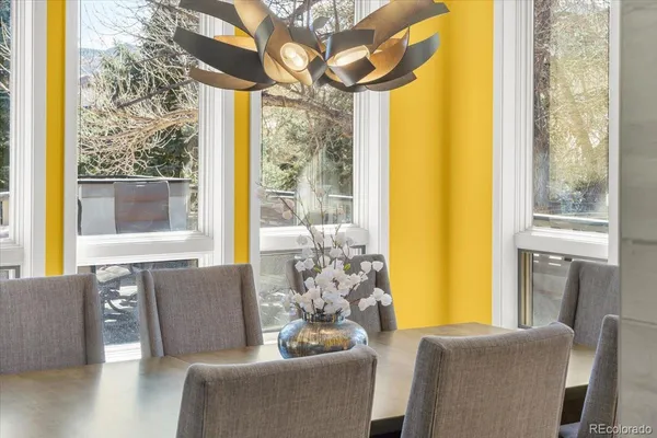 a living room with fireplace furniture and a large window