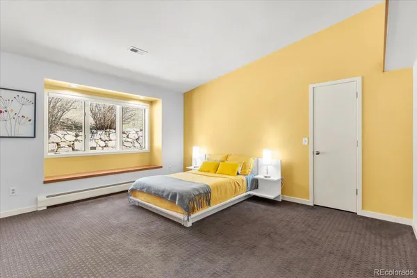 a bed room with a bed and a large window