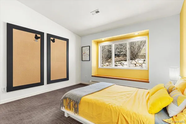 a bedroom with a bed and window