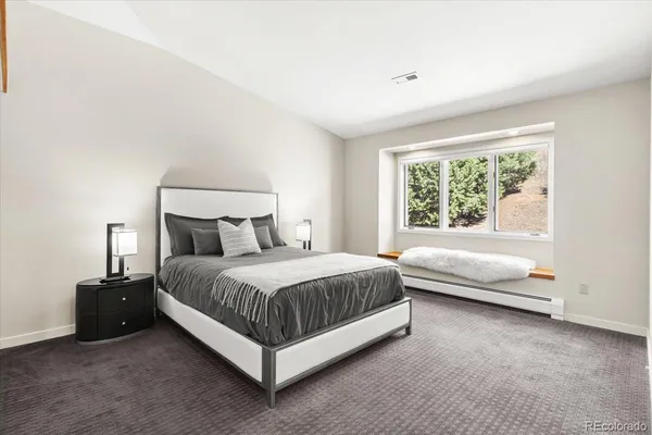 a bedroom with a bed and a couch