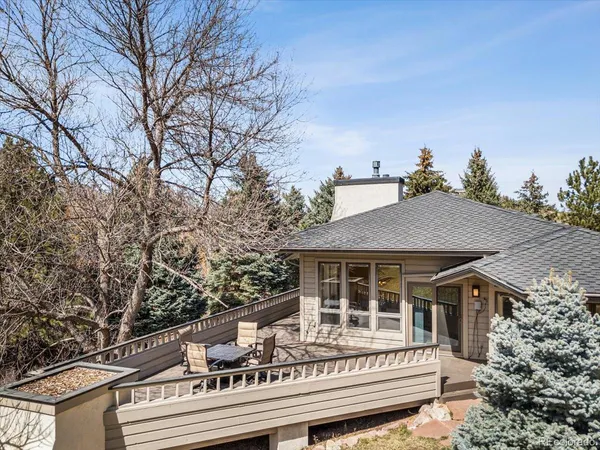 a house with tall trees in front of it