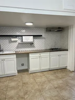 a kitchen with granite countertop a sink and cabinets