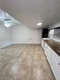 a view of a kitchen with a sink and cabinets