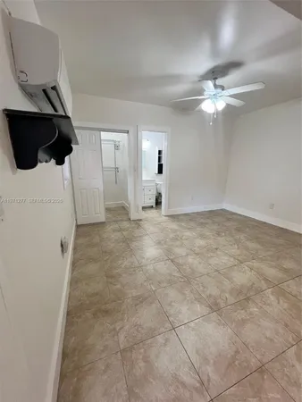 a view of a livingroom with a ceiling fan and window