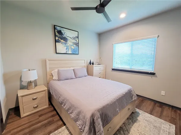 a bedroom with a large bed and a window