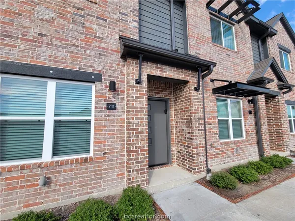 a view of a brick house with a large windows