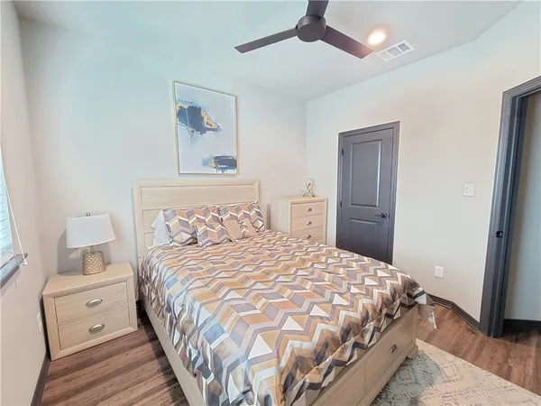 a bedroom with a bed and a painting on the wall