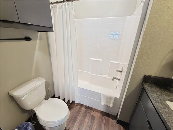 a white toilet sitting next to a sink