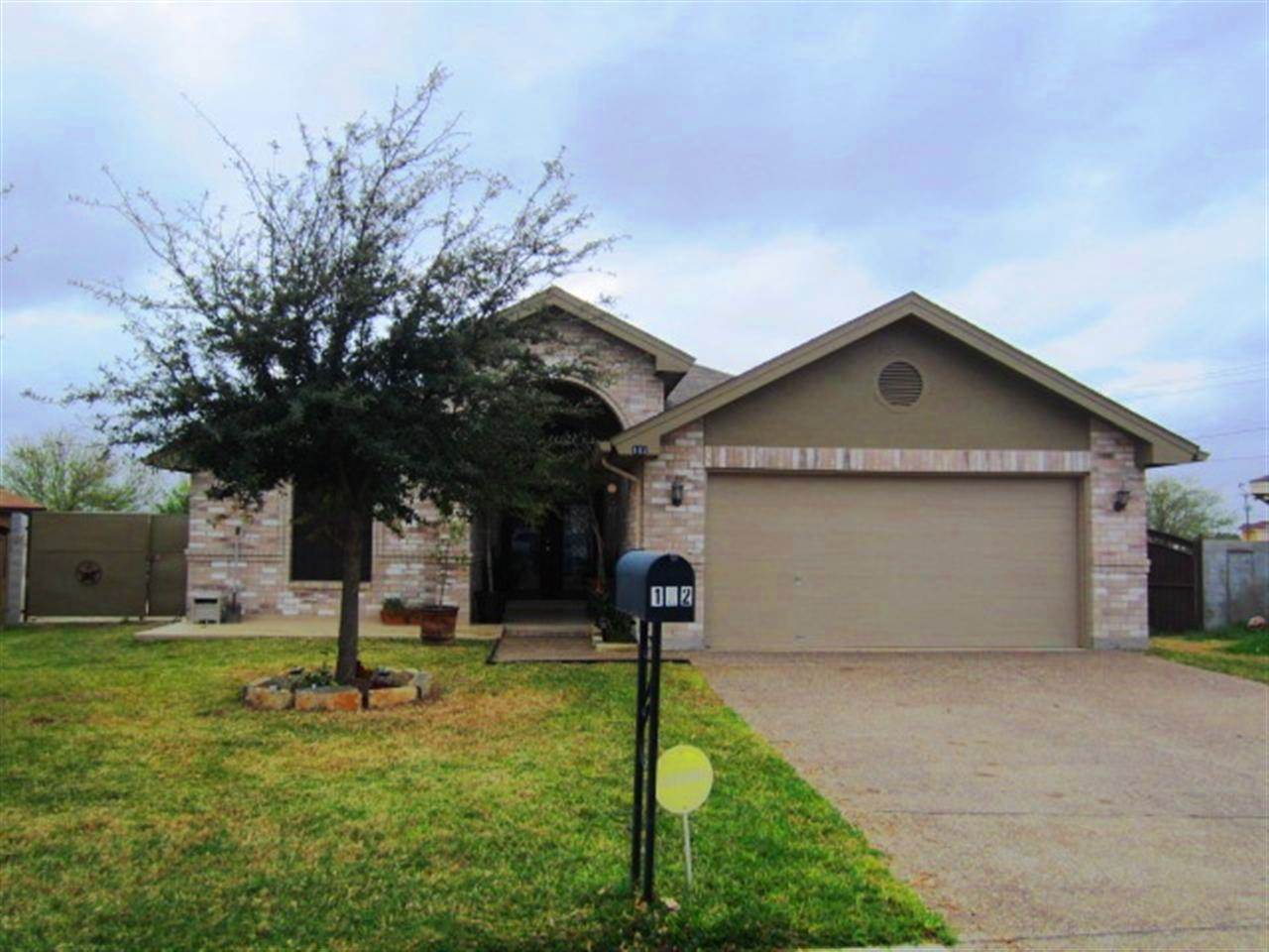 102 Sun Ray Loop Laredo, TX 78041 - Photo 1 of 9 a front view of house with yard
