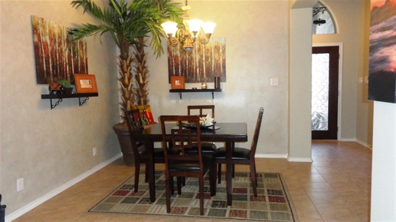 102 Sun Ray Loop Laredo, TX 78041 - Photo 3 of 9 a view of a dining room with furniture and a potted plant