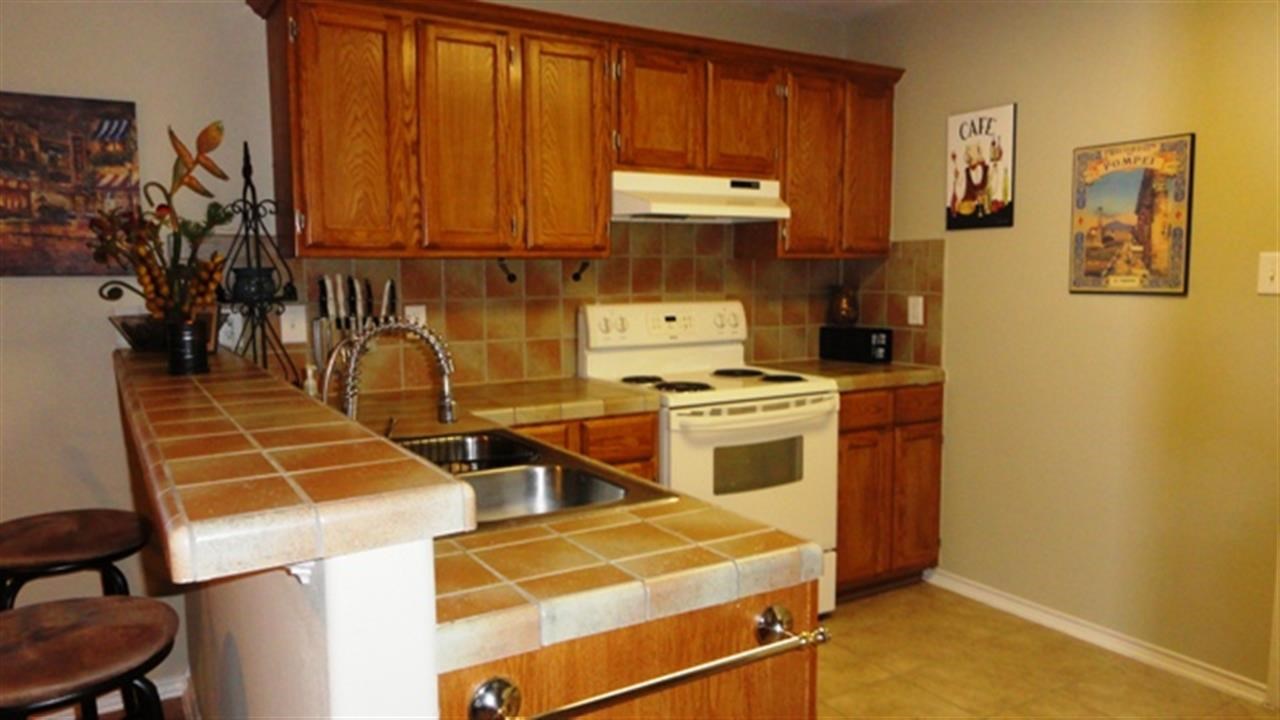 102 Sun Ray Loop Laredo, TX 78041 - Photo 5 of 9 a room with wooden floor and cabinets