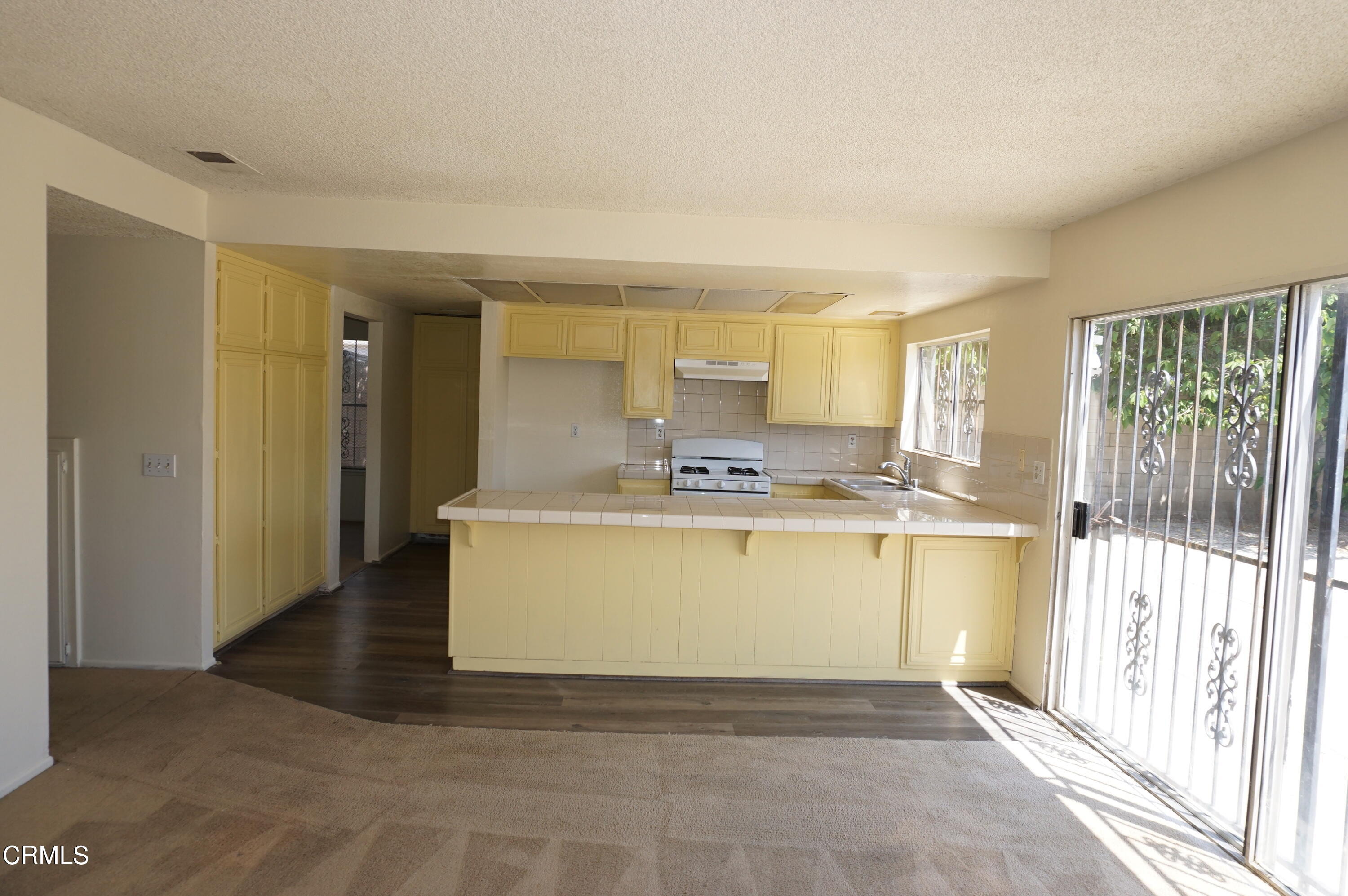 1500 Kipling Court Oxnard, CA 93033 - Photo 6 of 18 a view of a kitchen with kitchen island wooden floor and stainless steel appliances