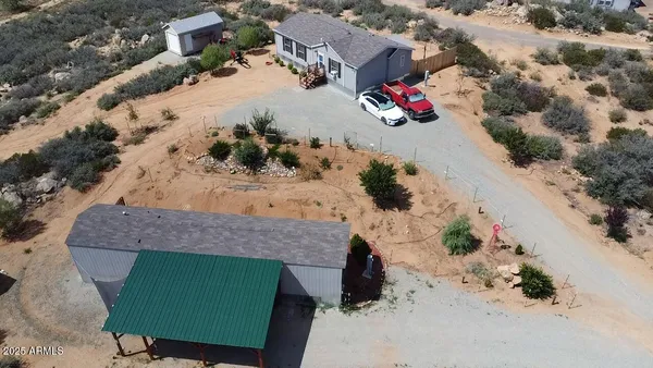 an aerial view of a house with a yard