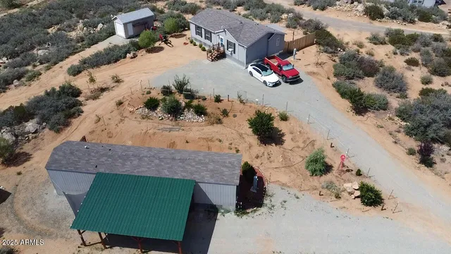 an aerial view of a house with a yard