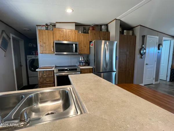 a kitchen with a refrigerator and a sink