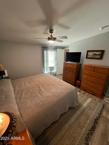 a bedroom with a bed and dresser with mirror