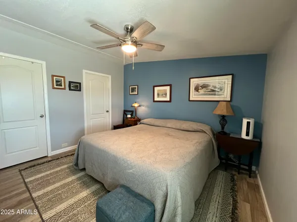 a spacious bedroom with a bed and a chandelier