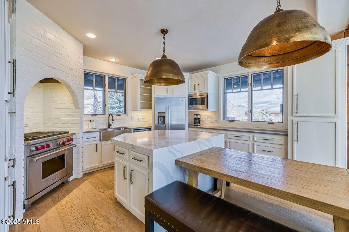 748 Hernage Creek Road Eagle, CO 81631 - Photo 1 of 44 a kitchen with kitchen island a stove and a wooden floor