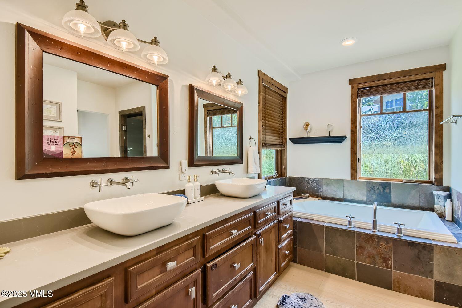 748 Hernage Creek Road Eagle, CO 81631 - Photo 17 of 44 a bathroom with a granite countertop sink and a large mirror