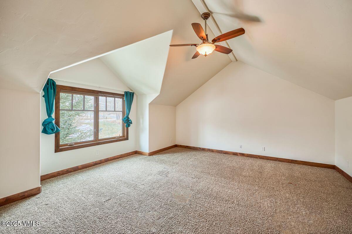 748 Hernage Creek Road Eagle, CO 81631 - Photo 24 of 44 an empty room with windows and ceiling fan view