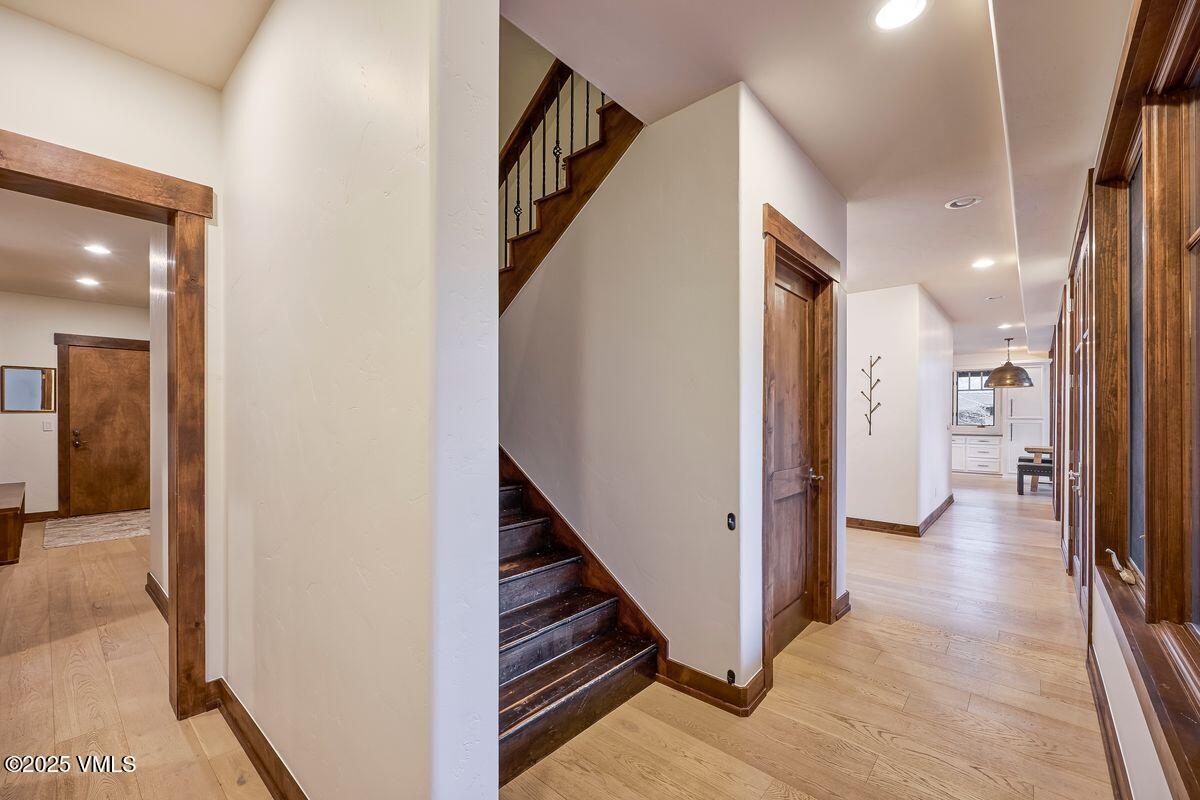 748 Hernage Creek Road Eagle, CO 81631 - Photo 27 of 44 a view of a hallway with wooden floor and staircase