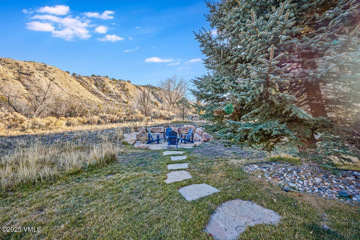 748 Hernage Creek Road Eagle, CO 81631 - Photo 37 of 44 a view of a yard with plants and a bench