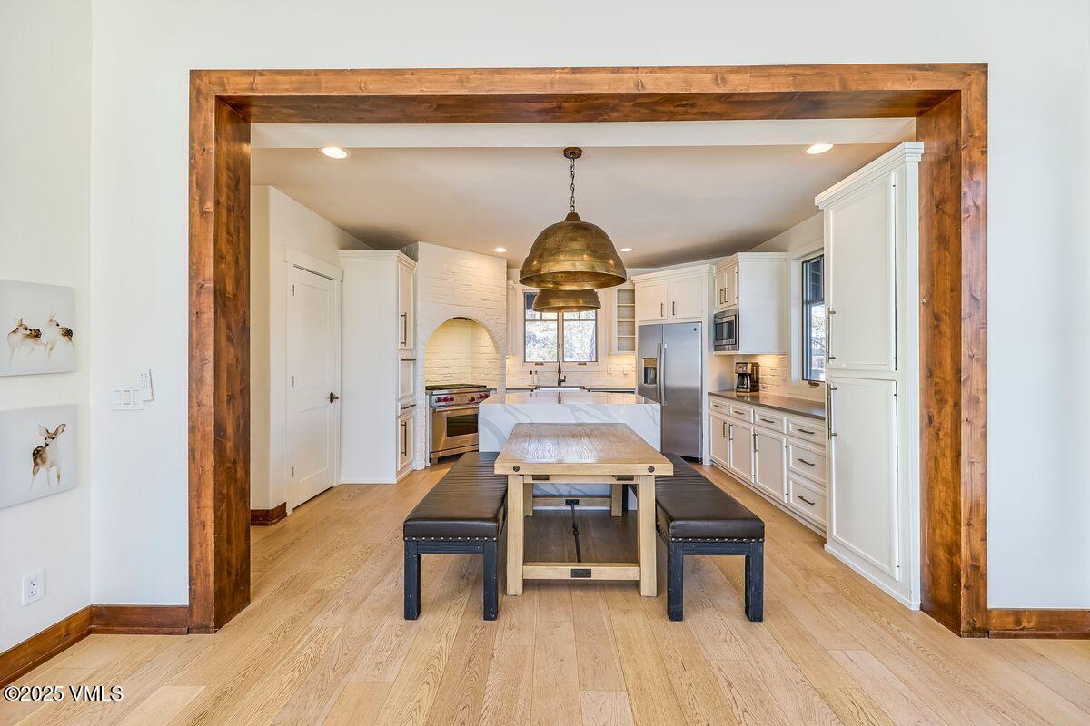 748 Hernage Creek Road Eagle, CO 81631 - Photo 7 of 44 a view of a hallway with wooden floor and furniture