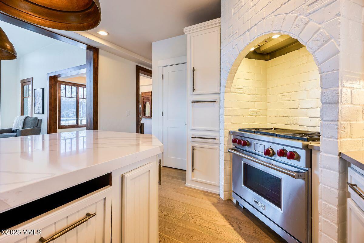 748 Hernage Creek Road Eagle, CO 81631 - Photo 8 of 44 a kitchen with a stove and a wooden floor