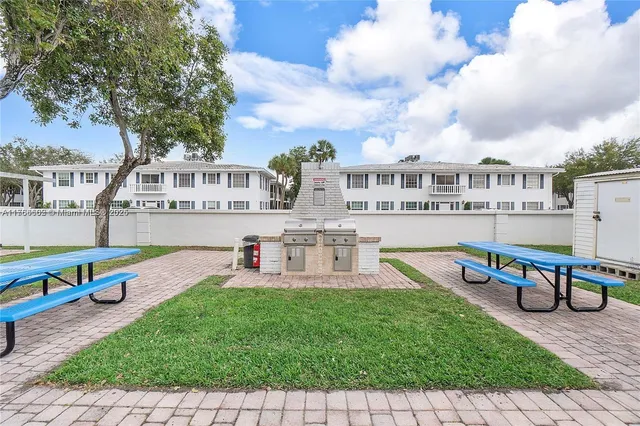 an aerial view of a house with swimming pool and patio