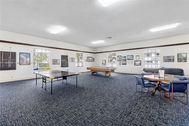 a living room with furniture a rug and a table