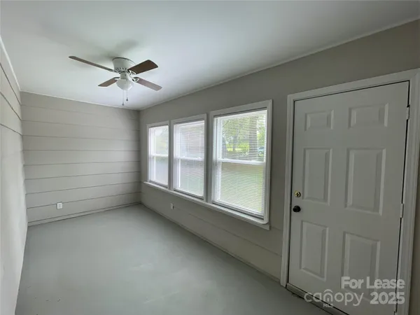 a view of room window and a ceiling fan