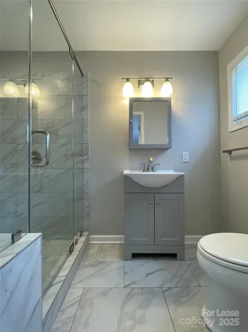 a bathroom with a sink toilet and shower