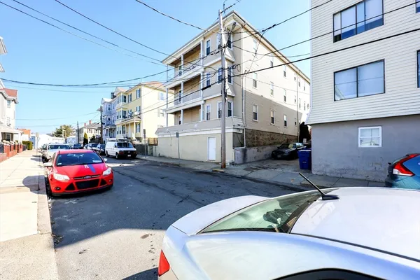 a view of a cars park in front of building