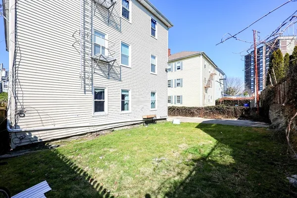 a view of a house with backyard and sitting area