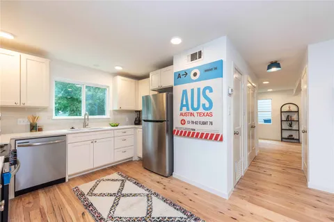 a kitchen with a refrigerator and a sink