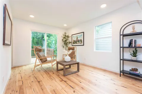 a living room with furniture and a wooden floor