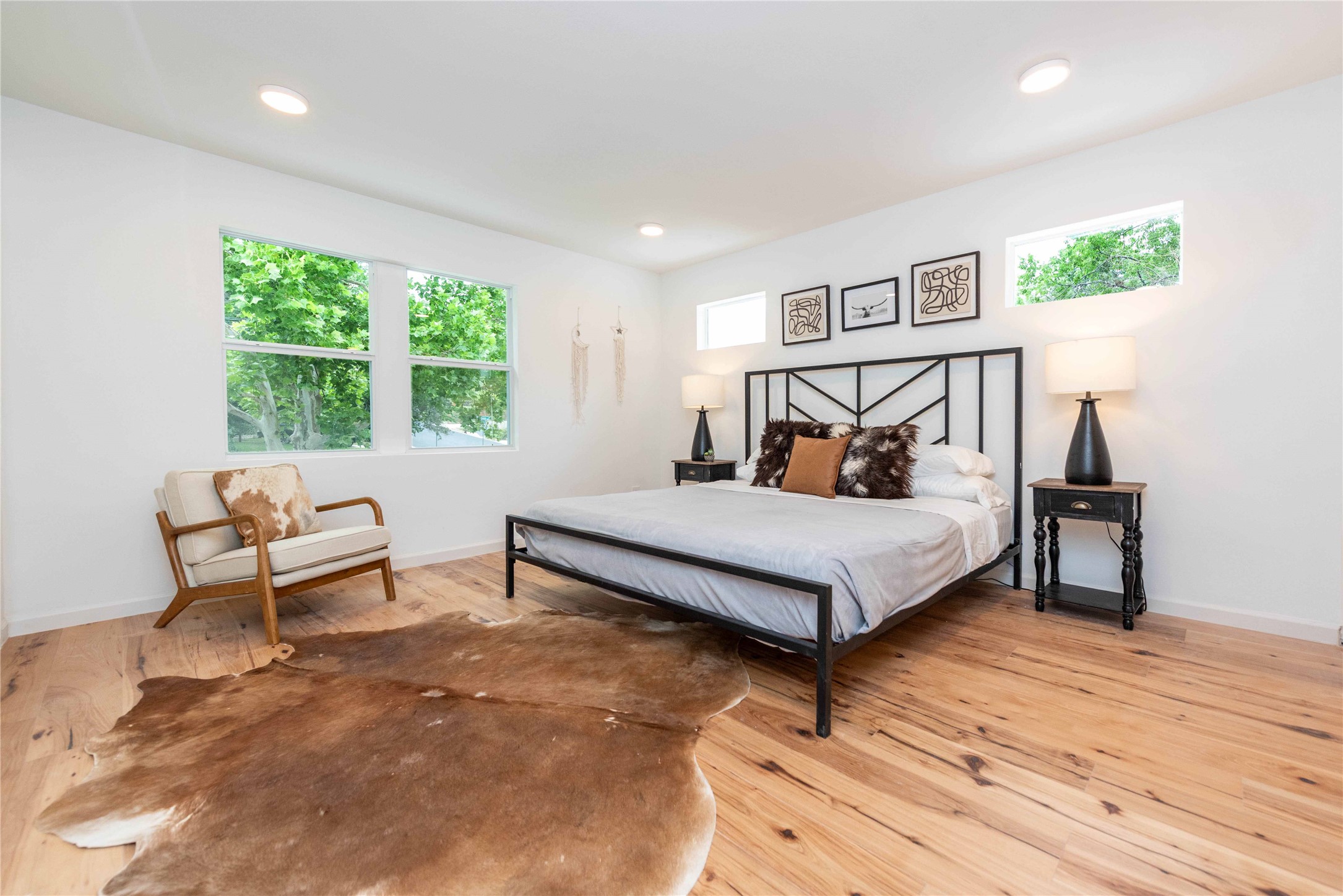 3801 Wilson Street Austin, TX 78704 - Photo 24 of 36 a bedroom with a bed lamp and a large window with wooden floor