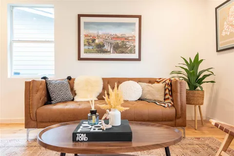 a living room with furniture and wooden floor