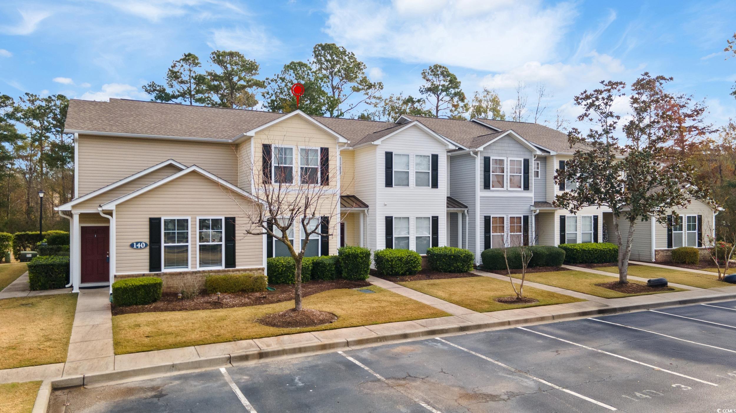 140 Olde Towne Way, Unit 2 Myrtle Beach, SC 29588 - Photo 2 of 40 Traditional-style house with uncovered parking, a residential view, roof with shingles, and a front yard