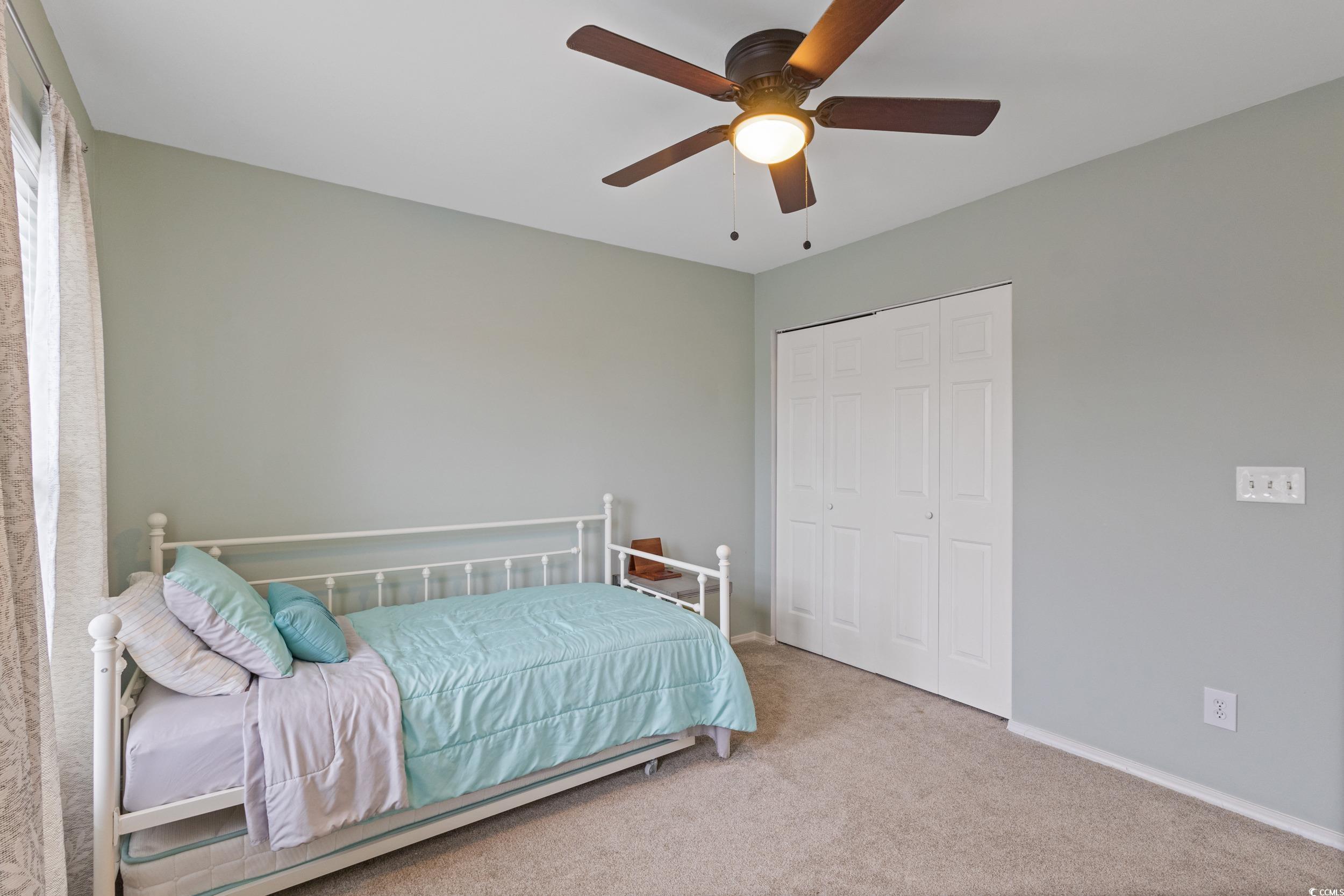140 Olde Towne Way, Unit 2 Myrtle Beach, SC 29588 - Photo 32 of 40 Bedroom featuring light colored carpet, a ceiling fan, and a closet