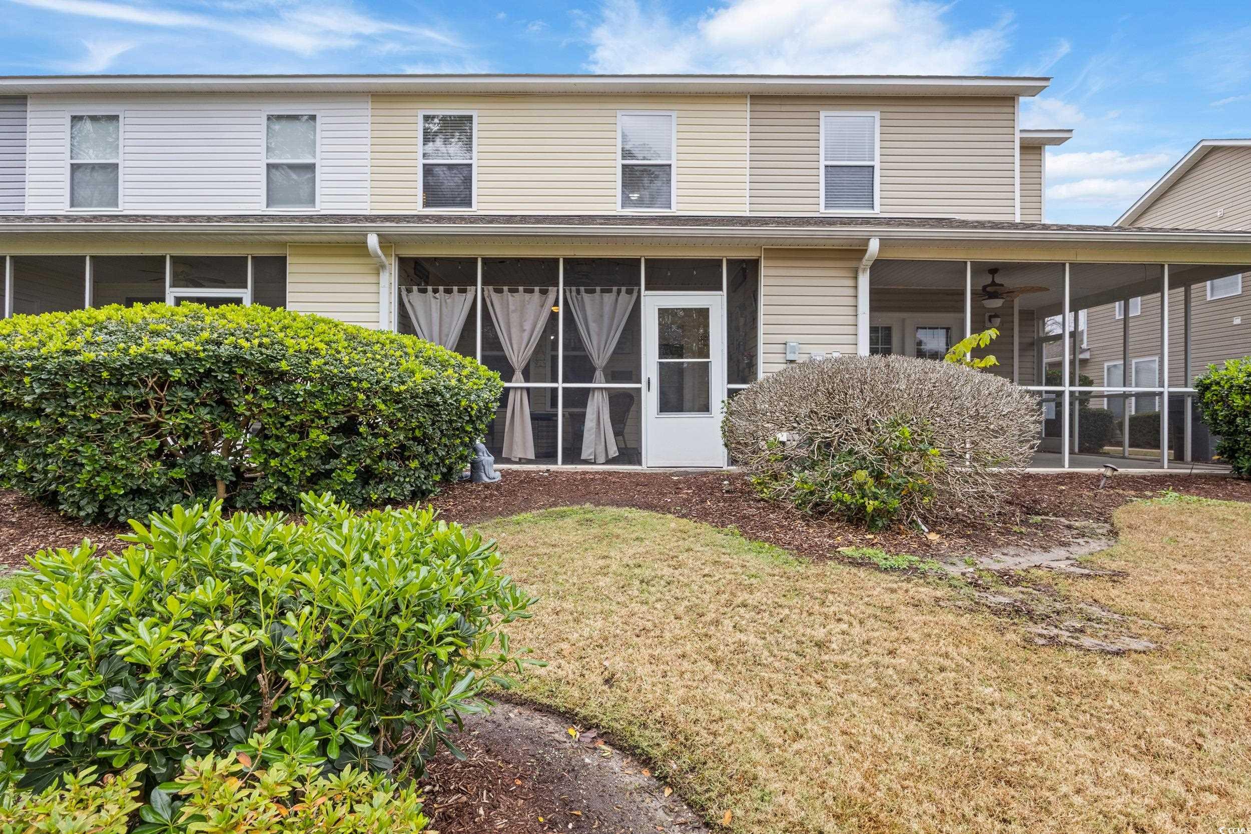 140 Olde Towne Way, Unit 2 Myrtle Beach, SC 29588 - Photo 36 of 40 Rear view of house featuring a sunroom and a lawn