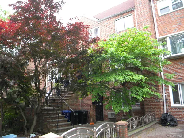 a view of a patio with table and chairs and potted plants