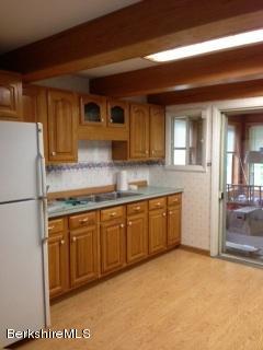 76 Pine Hollow Road Pownal, VT 05261 - Photo 11 of 17 a kitchen with stainless steel appliances granite countertop a refrigerator and a stove top oven