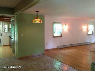 76 Pine Hollow Road Pownal, VT 05261 - Photo 6 of 17 an empty room with wooden floor and windows