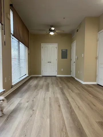 a view of an empty room with wooden floor
